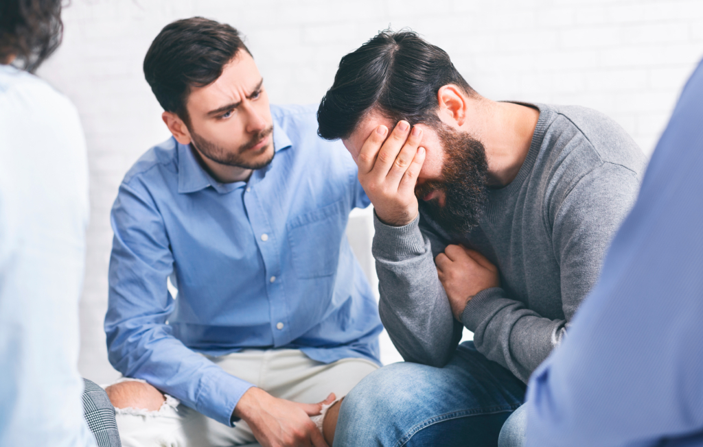 Man shows compassion to crying friend.