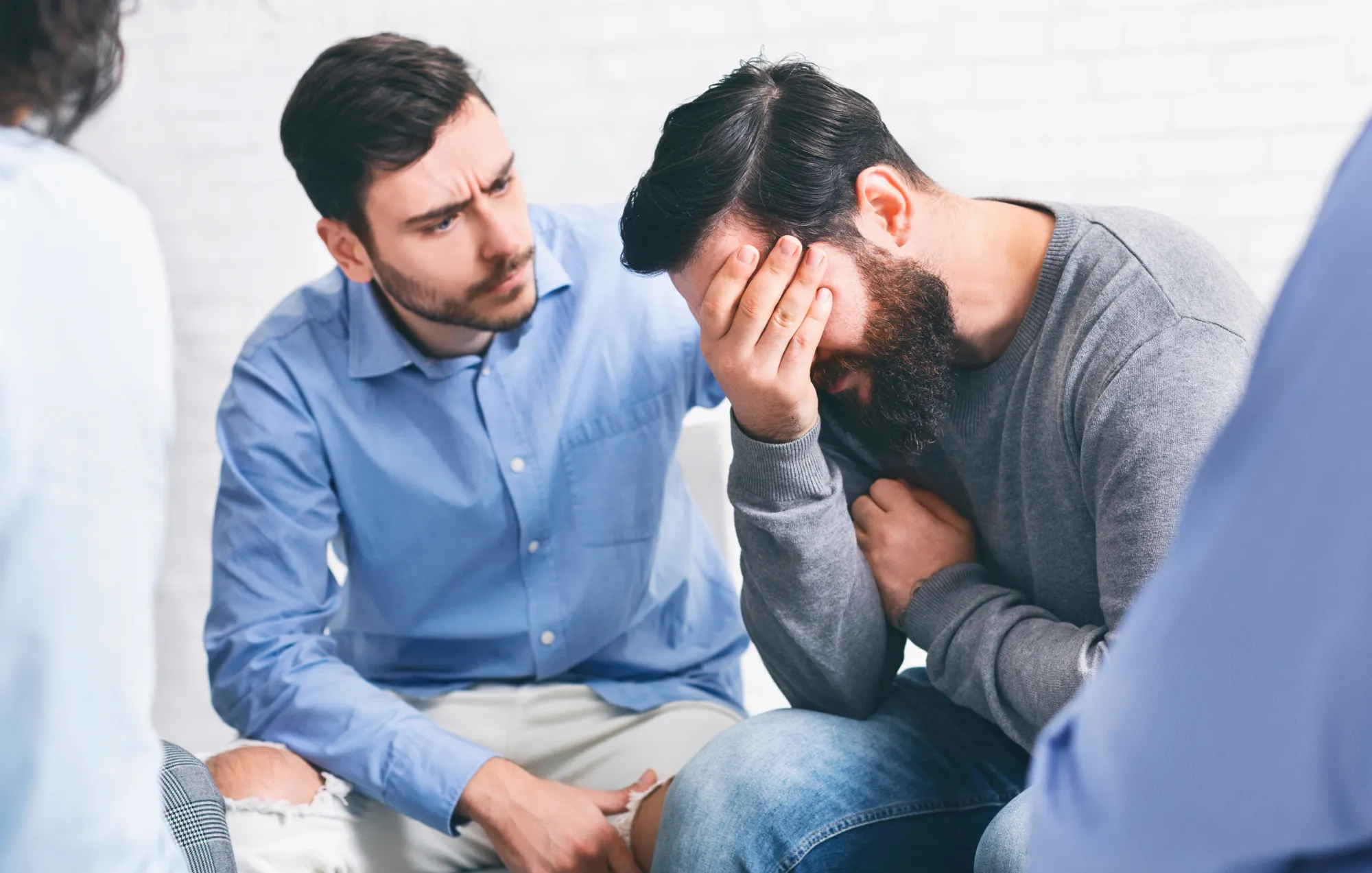 Man shows compassion to crying friend.